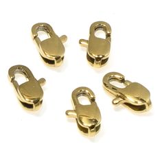 four brass plated metal clasps on white background