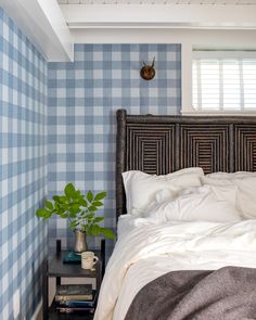 a bedroom with blue and white checkered walls