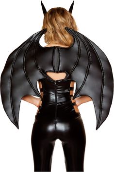 a woman in black leather is wearing a bat costume