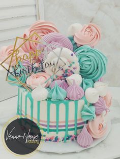 a birthday cake is decorated with pastel colors