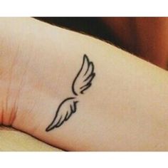 a person with a small tattoo on their arm that has a bird drawn on it