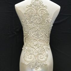 the back of a mannequin with beading on it