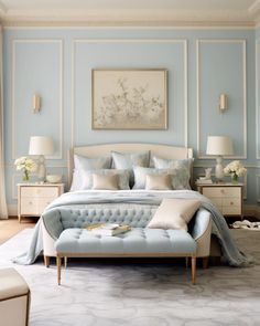 a bedroom with light blue walls and white furniture, including a tufted up bed