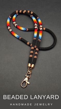 the beaded lanyard is shown on a black background