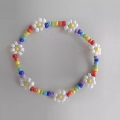 a multicolored beaded bracelet on a white surface