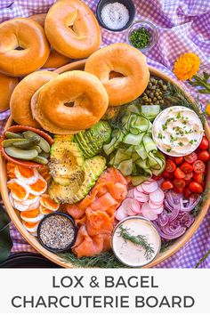 an overhead view of various bagels and vegetables in a bowl with the title fox & bagel charcuterie board