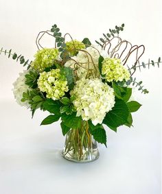 a vase filled with white and green flowers