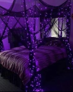 a bed with purple lights on it in a room