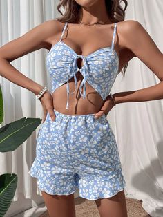 Introducing our Floral Print Front Ruffle Hem Cami Romper, a fun and feminine addition to your wardrobe. Featuring a floral pattern, this cami-style romper has spaghetti straps and a sleeveless silhouette. The tie front and cut-out details add a touch of flirty charm while the ruffle hem gives it a playful finish. With its short length and regular fit, this romper is perfect for any occasion. Dress it up with heels or keep it casual with sandals for a stylish and effortless look. Specifications: Beach Jumpsuits And Rompers With Spaghetti Tie Straps, Cute Printed Summer Jumpsuits And Rompers, Spring Floral Print Jumpsuits With Spaghetti Straps, Spring Vacation Jumpsuits And Rompers With Adjustable Straps, Summer Beach Cami Jumpsuits And Rompers, Spring Summer Jumpsuits And Rompers With Spaghetti Straps, Flirty Spring Jumpsuits And Rompers With Spaghetti Straps, Casual Floral Print Jumpsuits With Spaghetti Straps, Flirty Spring Jumpsuit With Spaghetti Straps