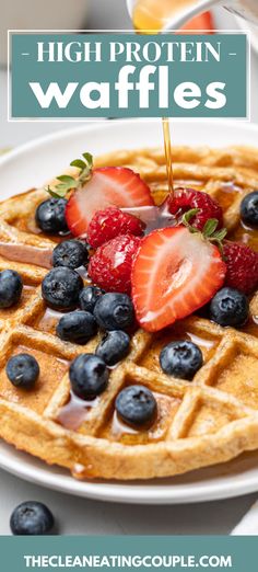 a waffle topped with strawberries and blueberries on top of a white plate