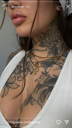 a woman with tattoos on her chest wearing a white top and black glasses is looking at the camera