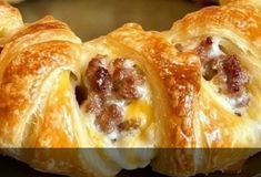 sausage and cheese crescent pastries on a baking sheet