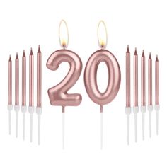 the number 20 candle is surrounded by many small candles in pink and white colors with one lit