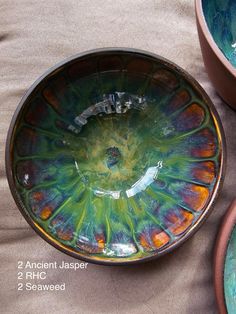 three bowls with different designs on them sitting next to each other and one bowl is empty