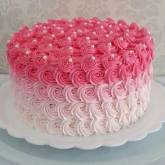 a pink and white cake on a plate