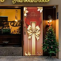 a christmas tree is in front of the entrance to a store with lights on it