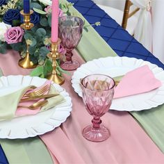 the table is set with pink and green place settings