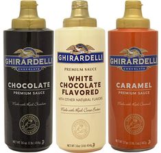 three different types of white chocolate flavored sprays are shown in this set up