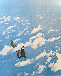 two men in suits are flying through the sky