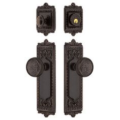 two black door knobs with ornate designs on the front and back of each one