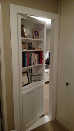 an open door leading into a room with bookshelves