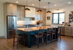 a large kitchen with an island in the middle