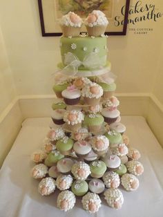 cupcakes are stacked on top of each other in the shape of a christmas tree