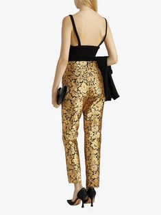 Cut for a tailored silhouette with pressed creases, these Dolce & Gabbana Metallic Jacquard Pants are designed to create bold, timeless look. The soft fabric is accented shimmering gold that adds an elegant finish. Zipper and button-closure pockets lend contemporary edge this chic design.Material: 83% Polyester 17% FiberZipper button closureLogo detailsMade in Italy Model 175cm/ 5'9" wearing IT 40Designed slim fit, tapered at hemFits true size, take your normal size IT42 Measurements:Waist: 74 c Glamorous Fitted Pants For Gala, Gold Silk Bottoms For Party, Elegant Festive Pants, Elegant Gold Silk Bottoms, Luxury Fitted Sequin Bottoms, Chic Fitted Pants For Gala, Elegant Silk Pants With Tapered Leg, Elegant Sequined Bottoms For Evening, Gold Formal Bottoms