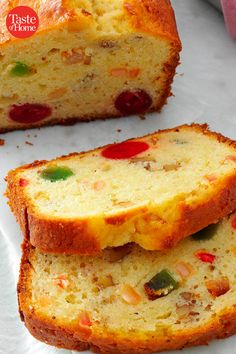 two pieces of bread with fruit on top and one slice cut off from the side