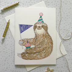 a card with a slotty bear holding a blue flag and wearing a party hat