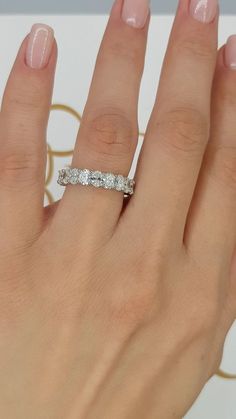 a woman's hand with a diamond ring on it