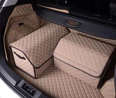 the interior of a car with beige carpeting and matching leather seats, including two storage bags