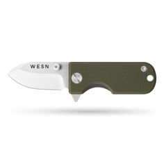 a knife that is sitting on top of a white surface with the words wern written on it