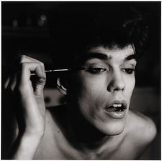 black and white photograph of a woman brushing her hair