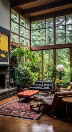 a living room filled with lots of furniture and large windows over the fire place in front of it