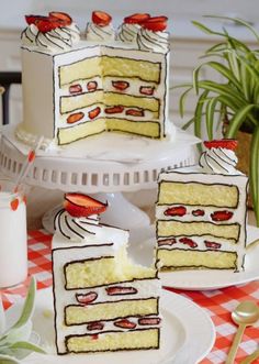 three pieces of cake sitting on top of a table next to plates and utensils