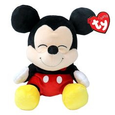 a mickey mouse stuffed animal with a heart on it's ear and eyes closed