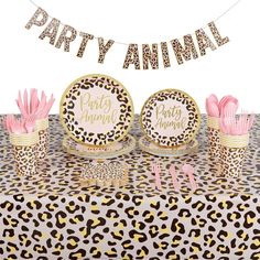 leopard print party table with pink napkins and plates