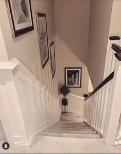 the stairs are lined with pictures and framed photographs