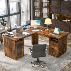 a computer desk sitting on top of a rug next to a window