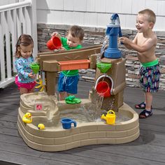 two children playing in a sand and water play set