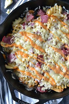 a skillet filled with macaroni and cheese covered in melted cheddar