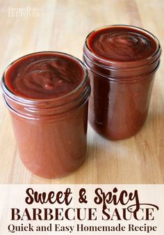 two jars filled with chocolate pudding sitting on top of a wooden table