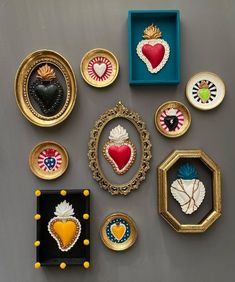 there are many decorative items on display in the box, including brooches and pendants