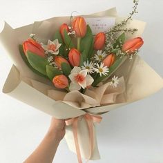 a person holding a bouquet of flowers in their hand