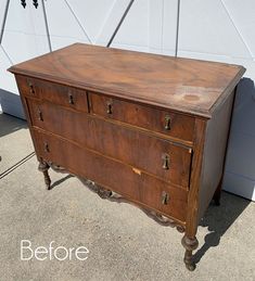 an old wooden dresser sitting in front of a white wall