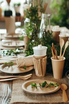 the table is set with plates, cups and utensils