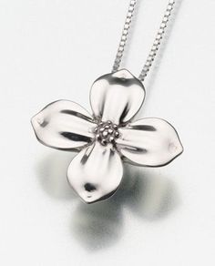 Part of our Cremation Jewelry collection is the Dogwood Blossom Pendant Urn. This beautiful keepsake pendant urn comes in Sterling Silver, Vermeil Gold or 14K Yellow or White Gold. Cremains are added through a screw back opening. A layer of silicone has been applied to each pendant, to avoid tarnishing. The shine may be restored by using a polish cream and a soft cloth for silver pendants. Includes a black satin cord.(Shown with optional Snake Chain) Dimensions: 1-1/4"wide x 1-1/"tall x 3/8"dept Dogwood Blooms, Flower Urn, Dogwood Blossoms, Cremation Necklaces, Dogwood Flowers, Urn Pendant, Urn Jewelry, Keepsake Urns, Memorial Necklace