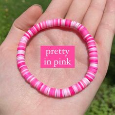 a pink and white bracelet that says pretty in pink on it's front end