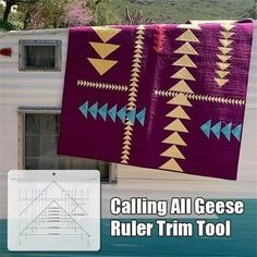 an image of a quilt hanging on the side of a building with text that reads, calling all geee ruler trim tool